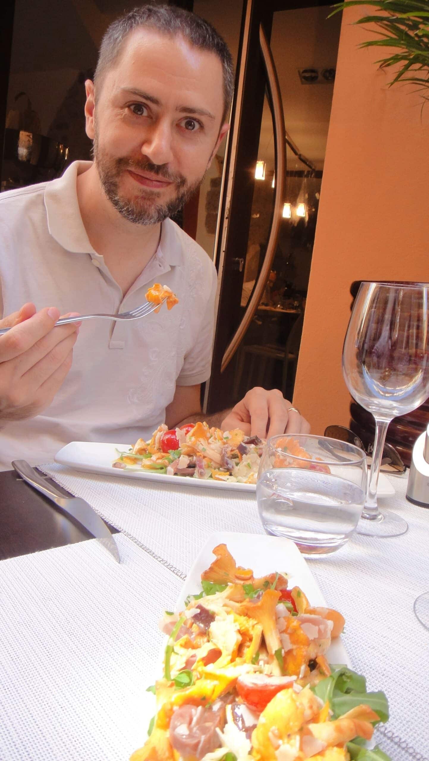 Un homme à table, une entrée composée au premier plan.