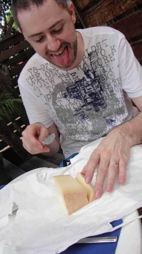 Un homme tire la langue devant son sandwich tout juste déballé.